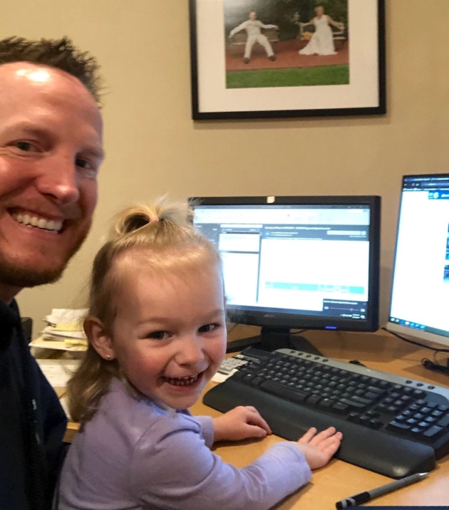 Operations Manager Ryan Munn and his daughter working from home during Covid-19.